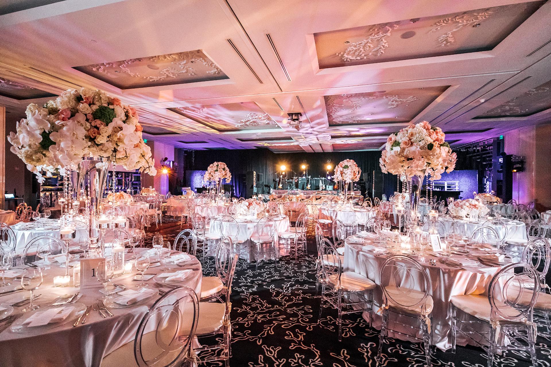 corporate event planner Miami luxury gala event setup with elegant table decor and ballroom lighting