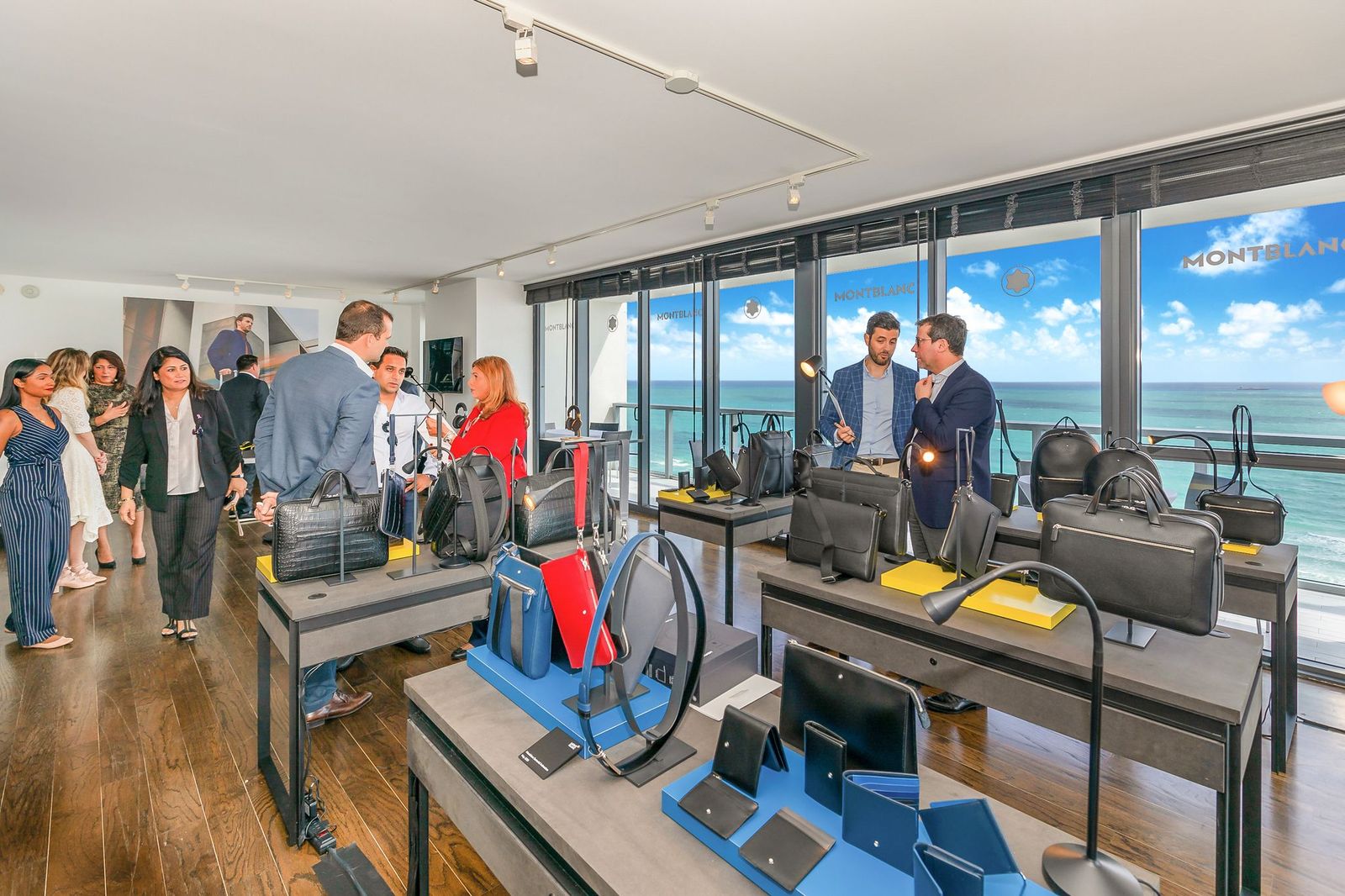 corporate event planner Miami product launch event with display setup and guests interacting