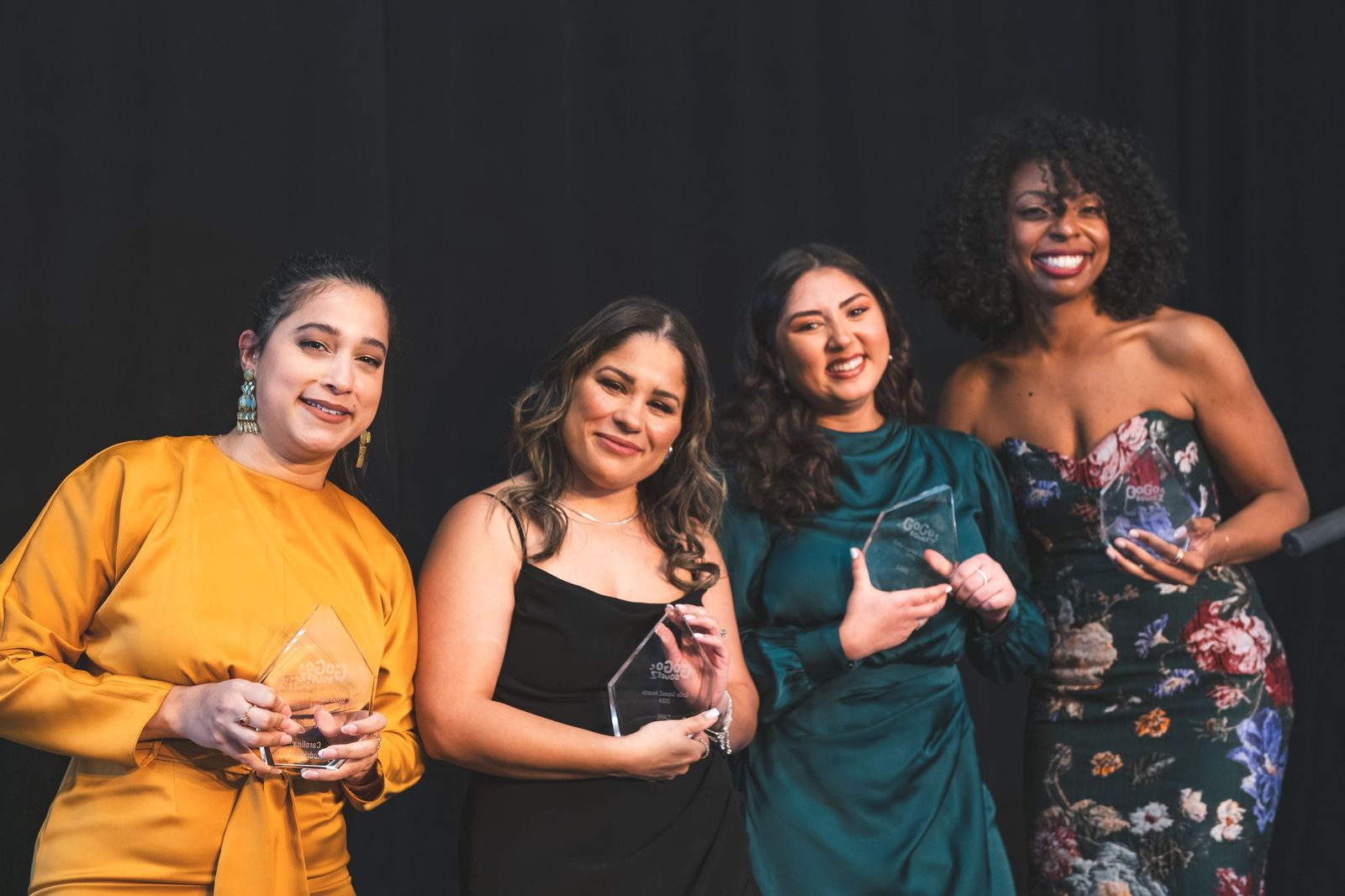 corporate event planner Miami awards ceremony with team members holding recognition trophies